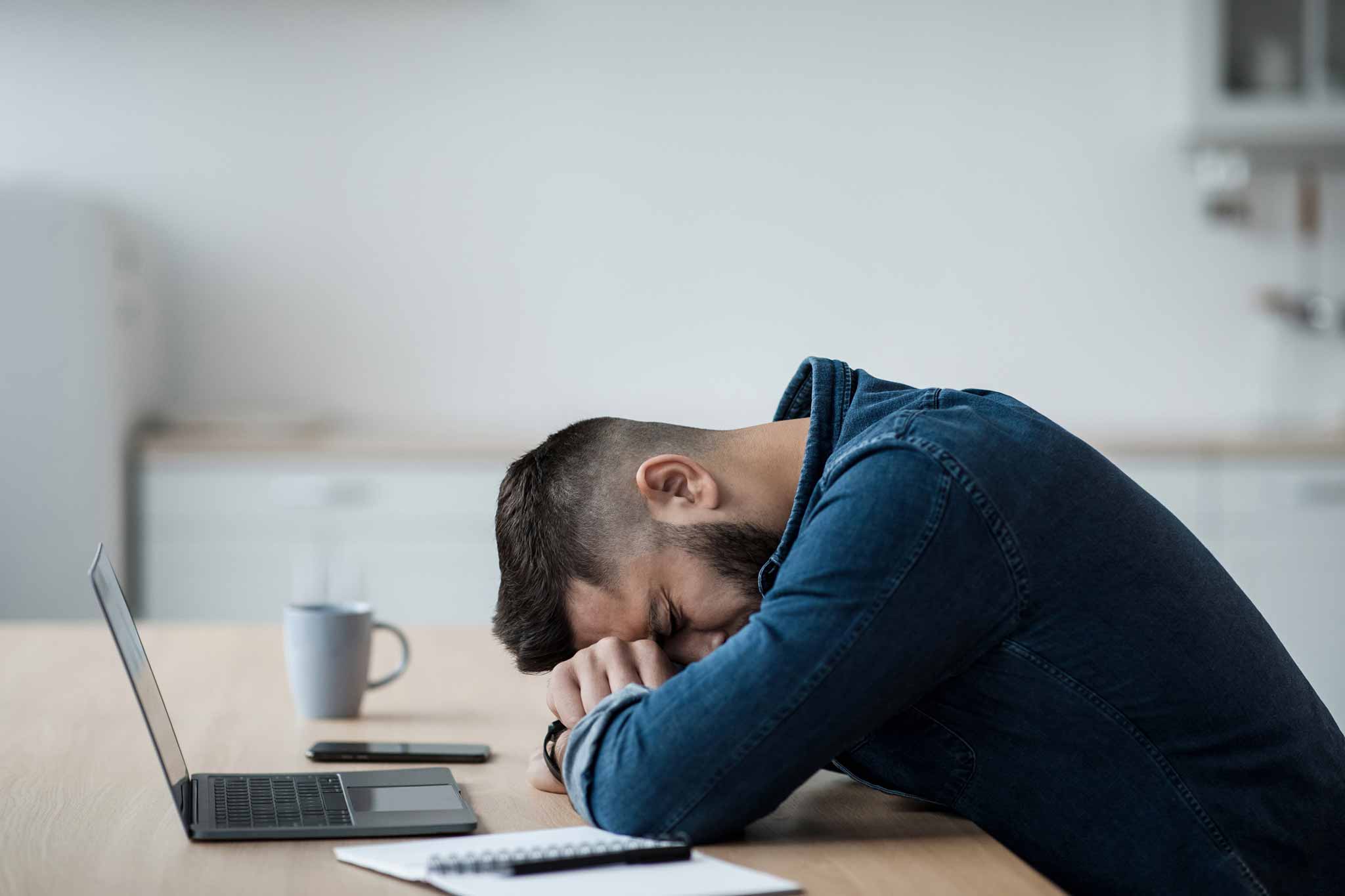 man experiencing mental fatigue at work